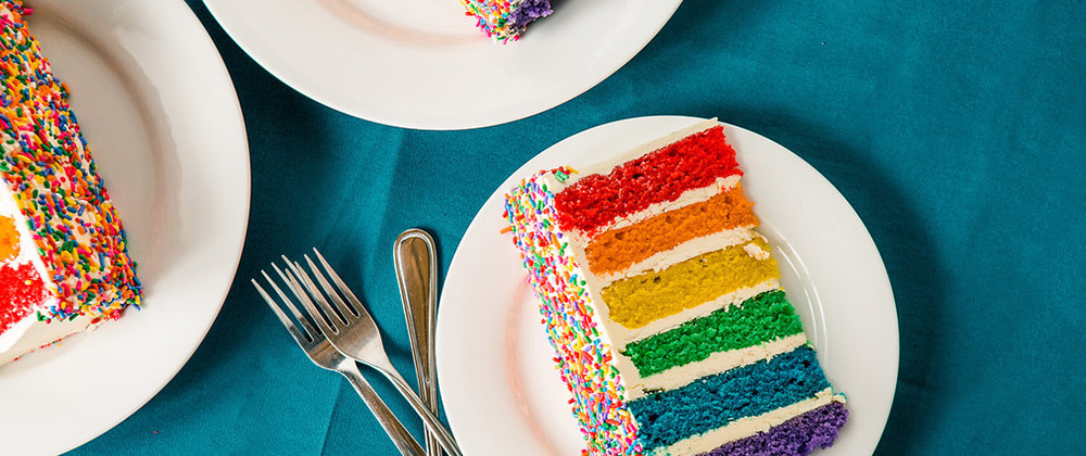 Photo of rainbow colored slices of cake