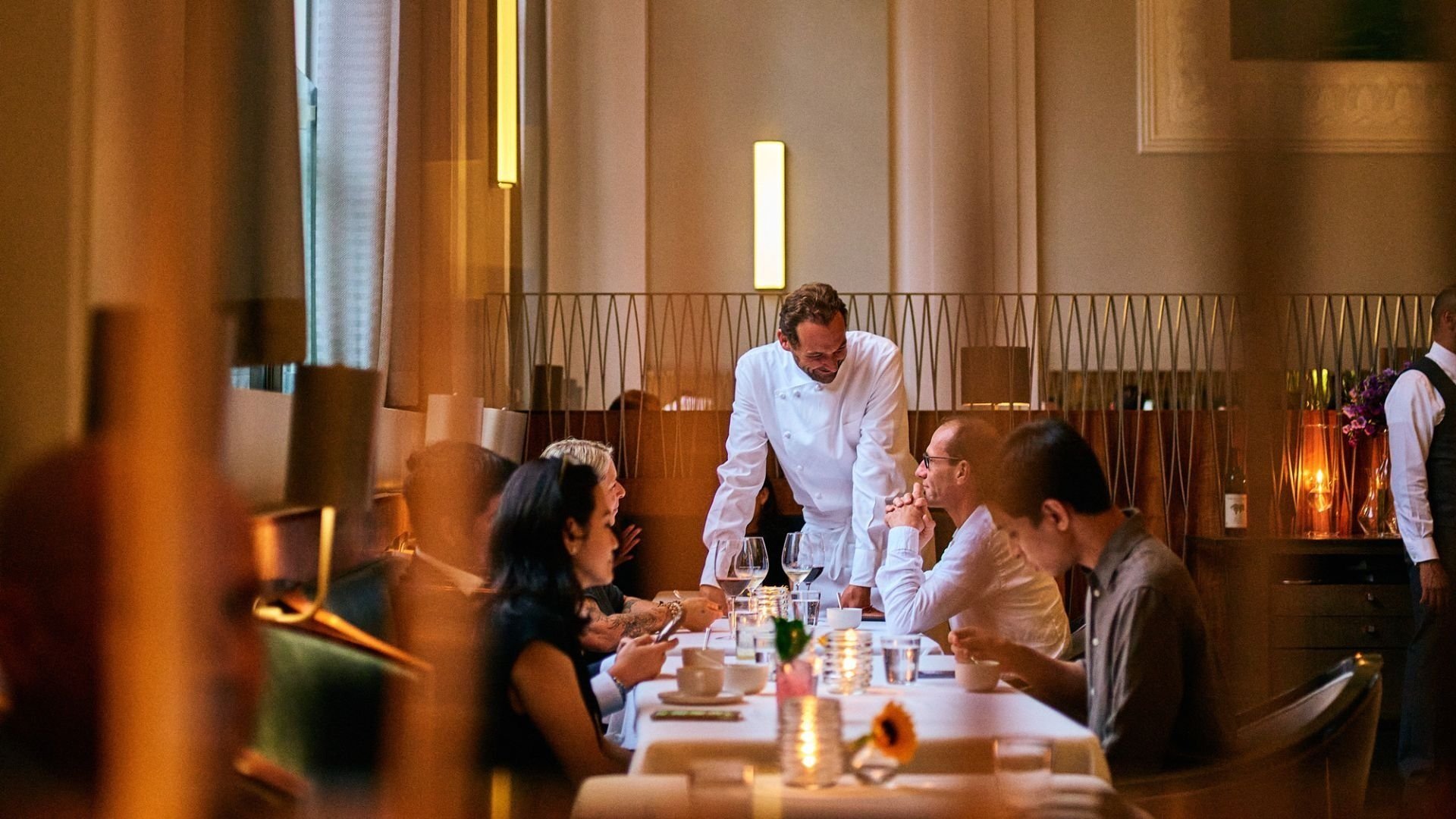 Chef Daniel Humm chatting with guests in the dining room