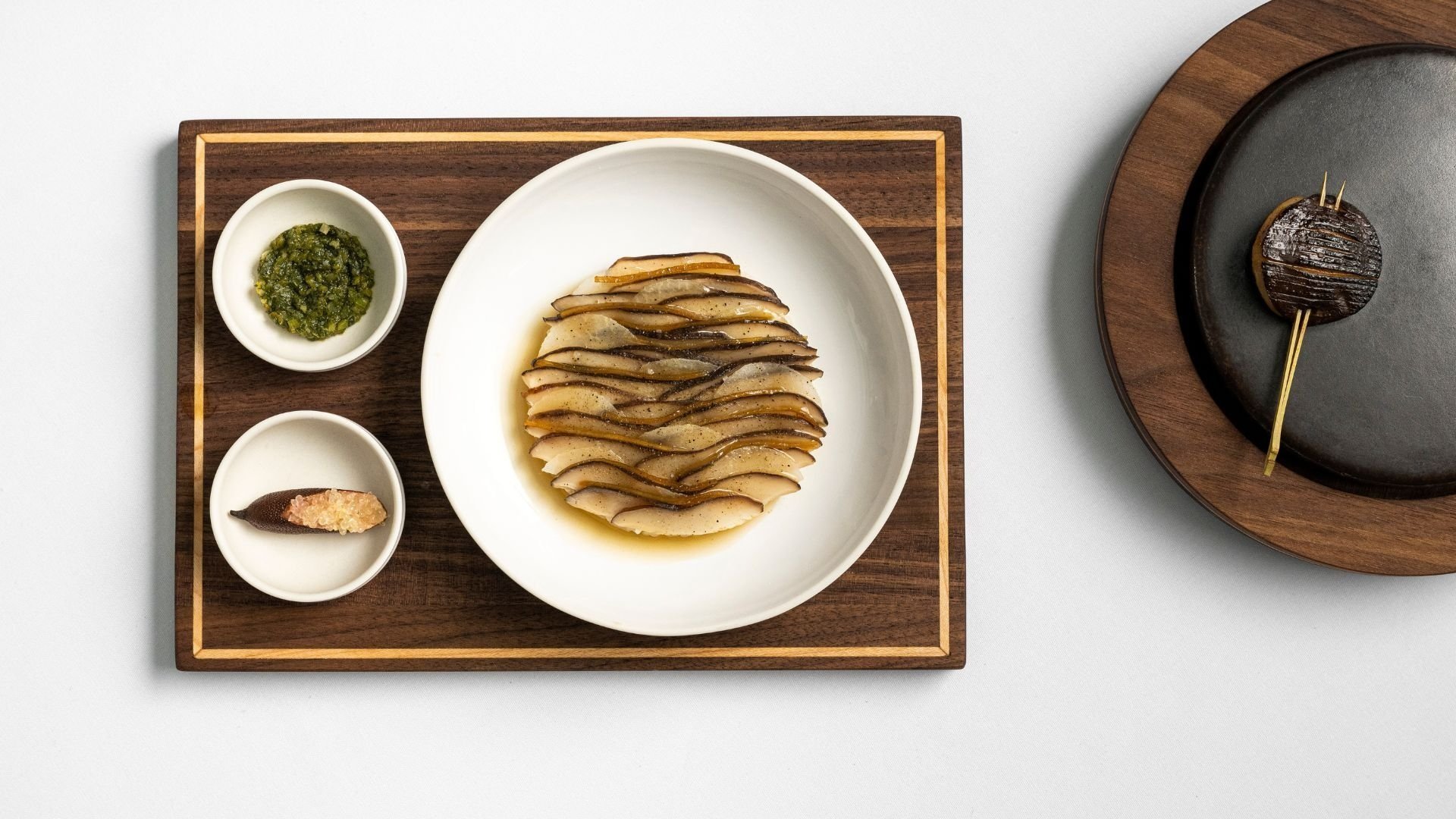 Mushroom dish on wooden board and white tablecloth 